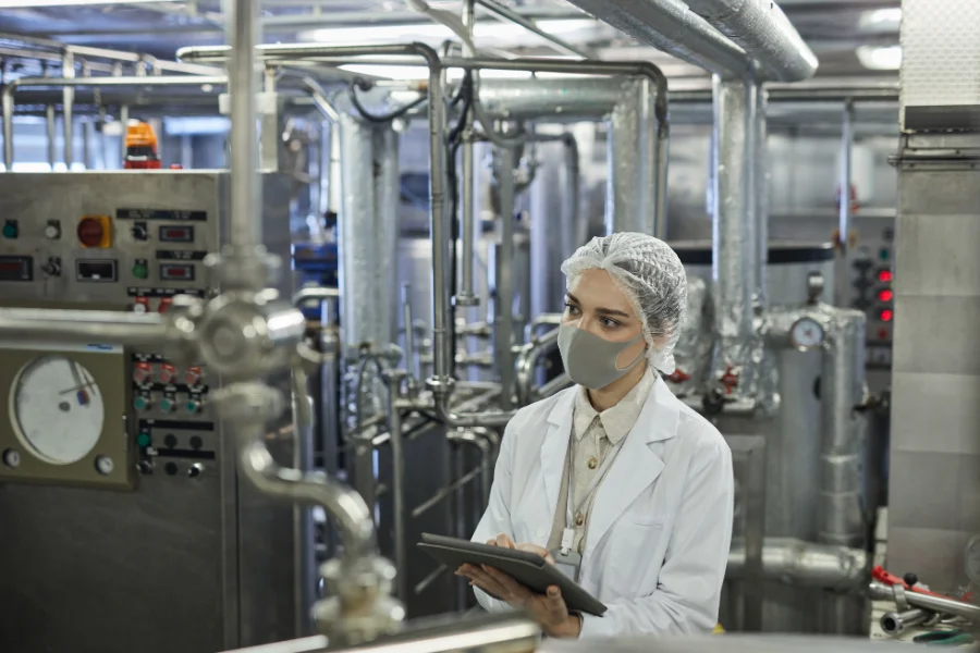 Production quality control: review evidence and risk areas (photo of a worker checking the machine’s condition)