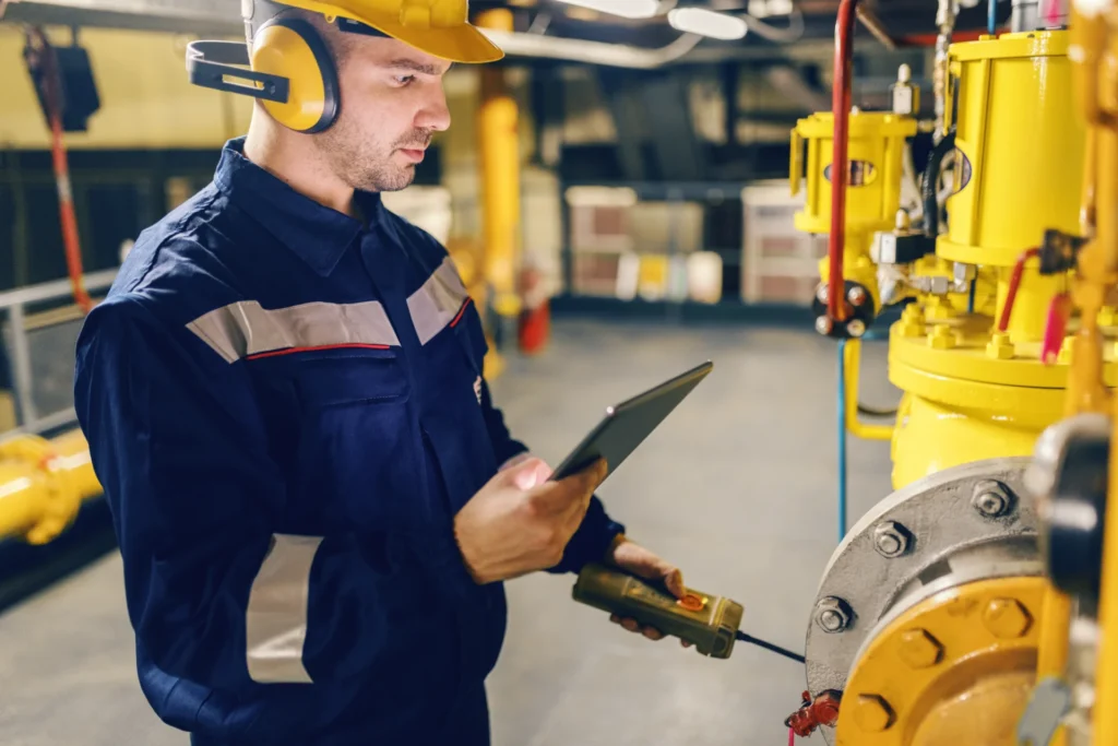 5 OEE calculation mistakes – how to improve manufacturing efficiency? (operator checking measurements)