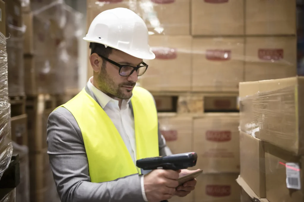 MES vs WMS - how do you start integration without creating a silo?
(photo of a warehouse worker scanning a package)